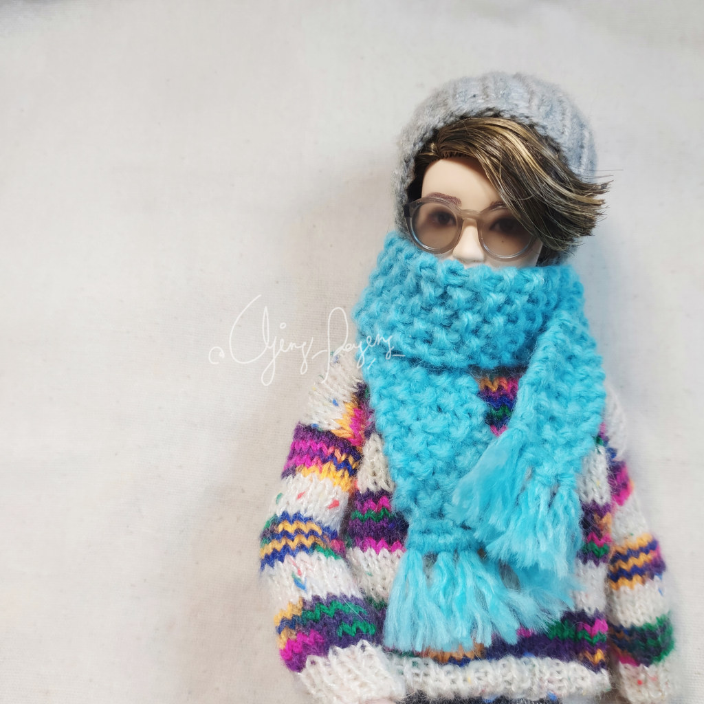 Tiny knitted mini scarf for a fashion doll made from leftover yarn